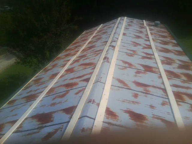 Rusted metal roof panels with new wood purlins before replacement — Storm Damage Roof Repair in Ukiah by Roofing Brothers
