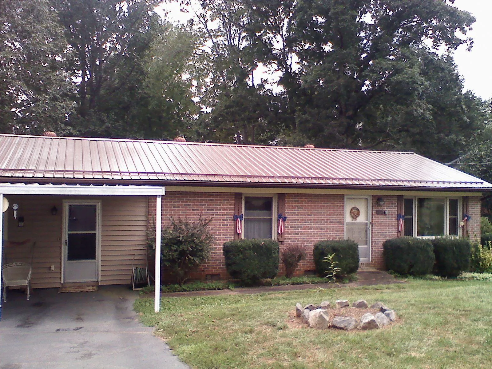 Bronze metal roof and carport on a brick ranch home — Roof Repair work by our crew in Ukiah